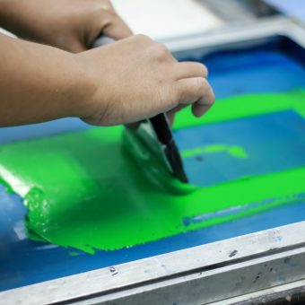 Hand pressing silk-screen printing, close up view.